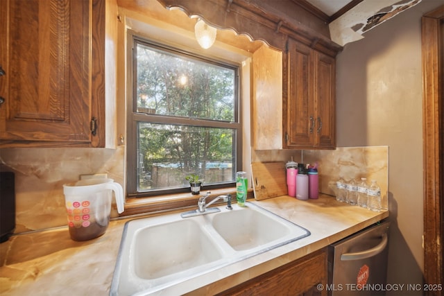 kitchen featuring sink, backsplash, and a healthy amount of sunlight