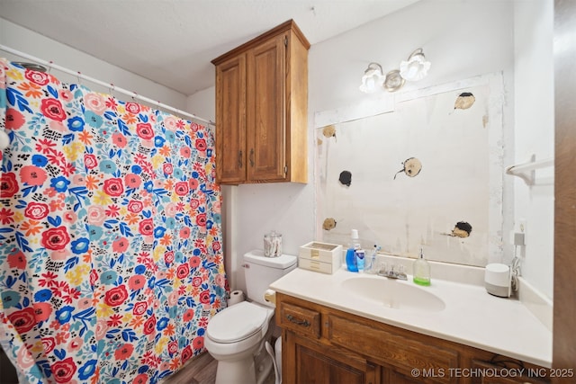 bathroom with vanity, hardwood / wood-style floors, and toilet