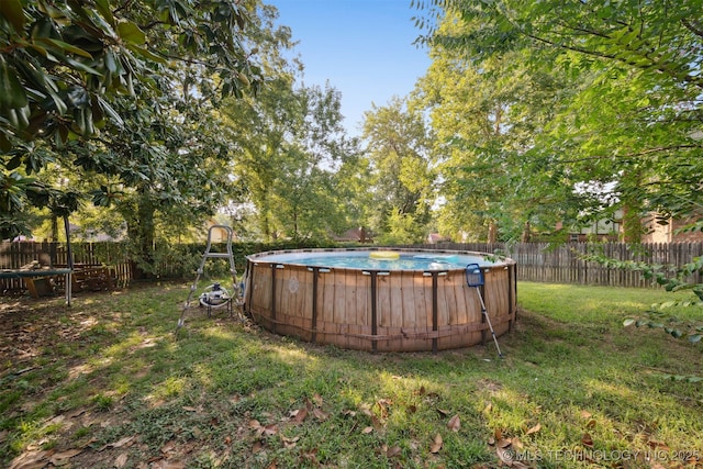 view of yard with a fenced in pool