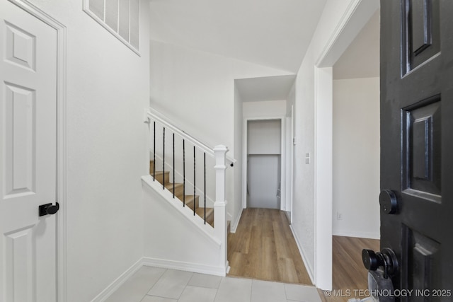 tiled foyer entrance featuring lofted ceiling