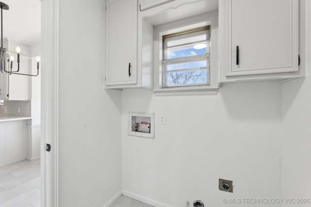 clothes washing area featuring an inviting chandelier, cabinets, hookup for an electric dryer, and hookup for a washing machine