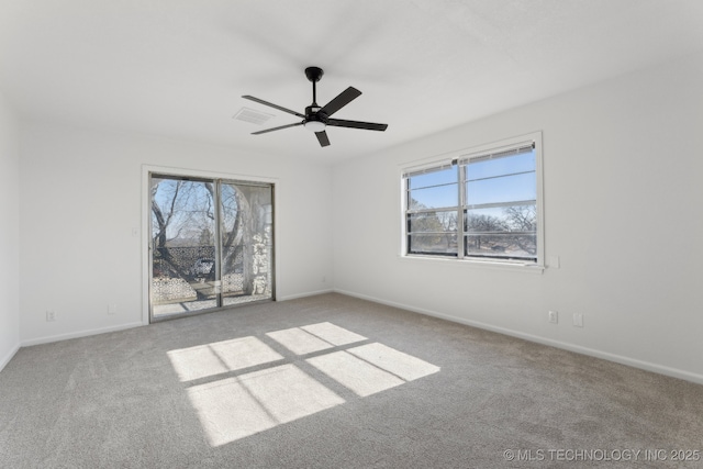 empty room featuring ceiling fan and light colored carpet