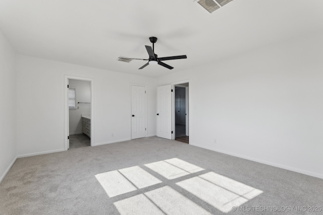 unfurnished bedroom with ceiling fan, ensuite bath, light colored carpet, and a closet