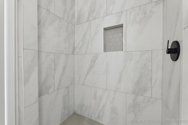 interior details with a tile shower