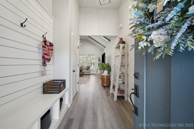 mudroom featuring lofted ceiling and light hardwood / wood-style flooring