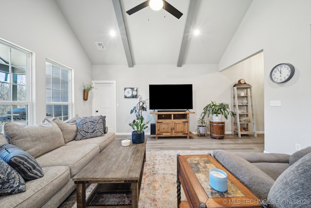 living room with hardwood / wood-style flooring, ceiling fan, and lofted ceiling with beams