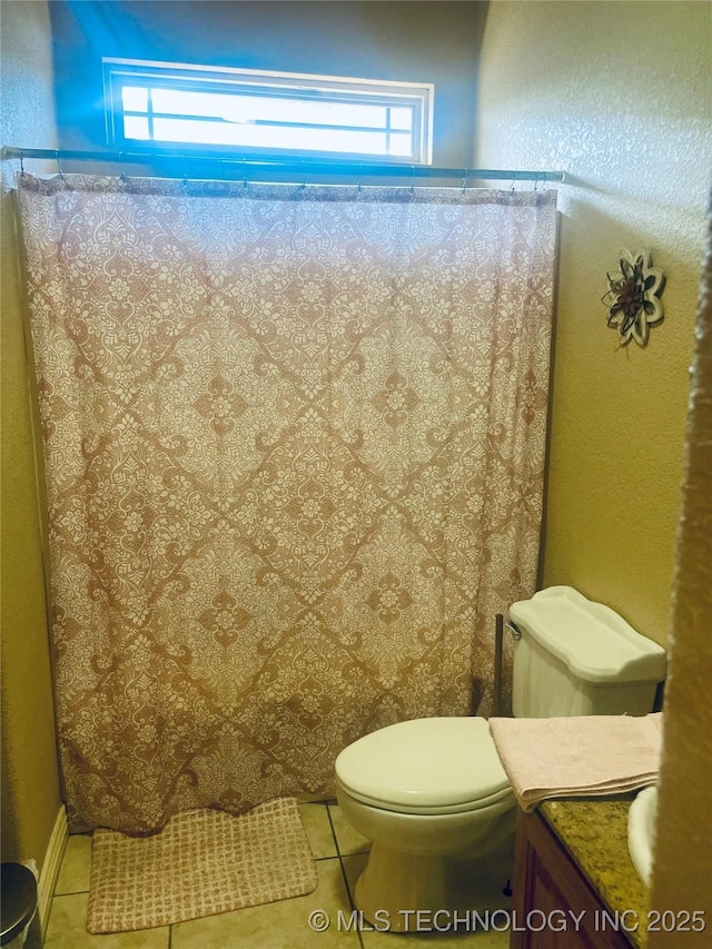 bathroom with tile patterned flooring and toilet