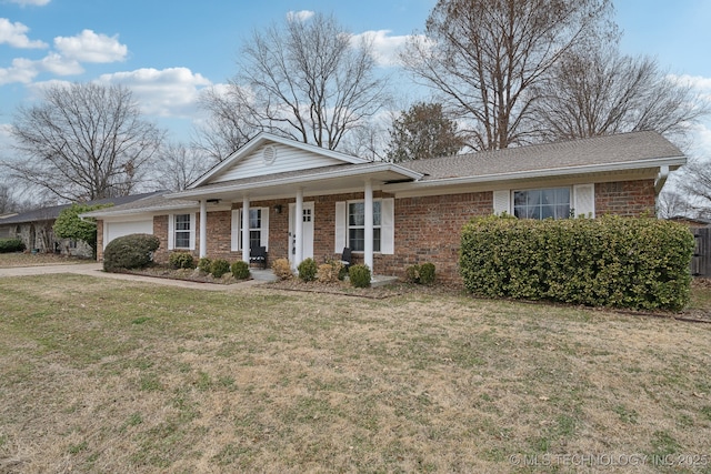 view of front facade featuring a garage, brick siding, and a front lawn