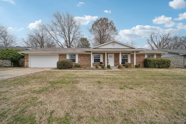 view of front of house with a front yard, a porch, an attached garage, concrete driveway, and brick siding