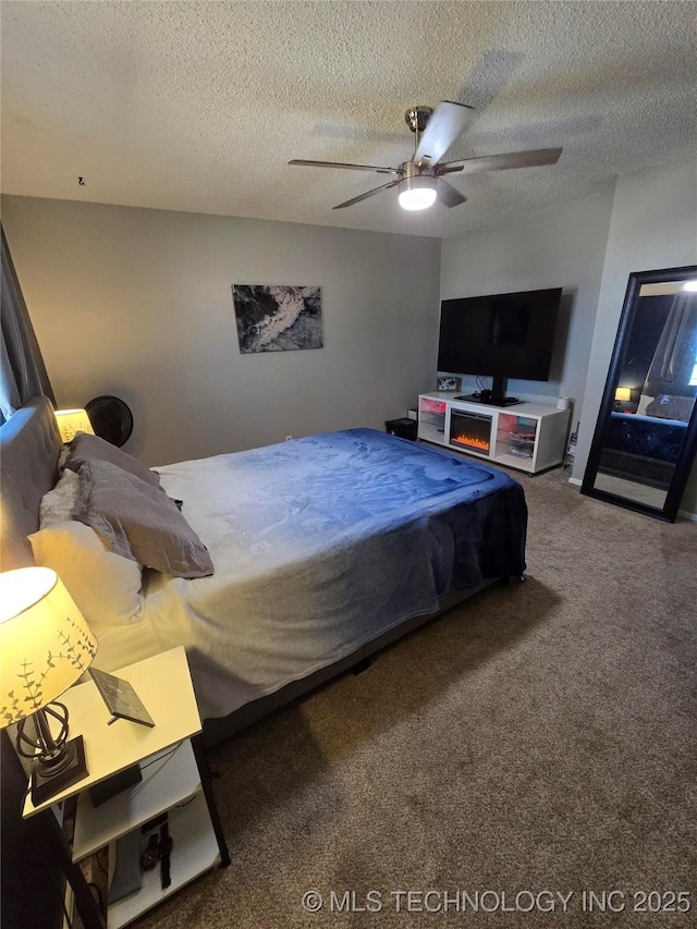 bedroom with carpet, a textured ceiling, and ceiling fan