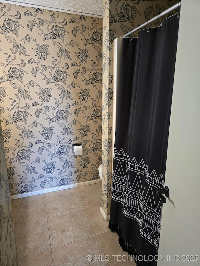 bathroom with tile patterned floors and toilet