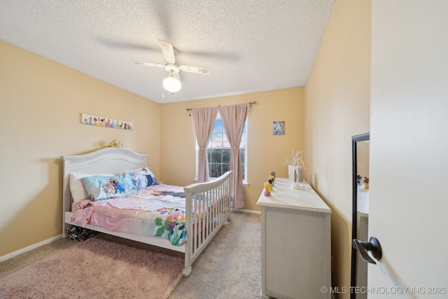 bedroom featuring ceiling fan, light colored carpet, baseboards, and a textured ceiling