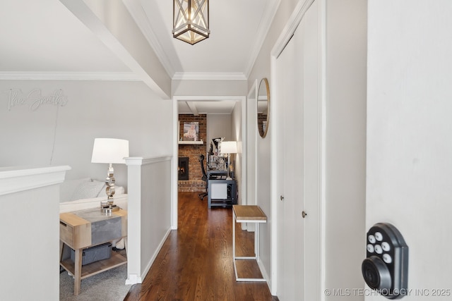 corridor featuring baseboards, dark wood-type flooring, and crown molding