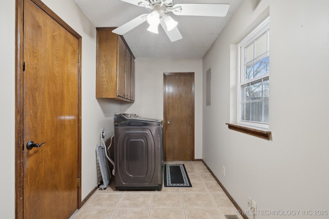 washroom with light tile patterned flooring, cabinet space, a textured ceiling, and baseboards