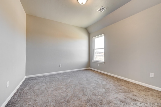 unfurnished room featuring vaulted ceiling and carpet floors