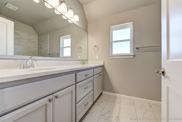 bathroom with vanity and lofted ceiling