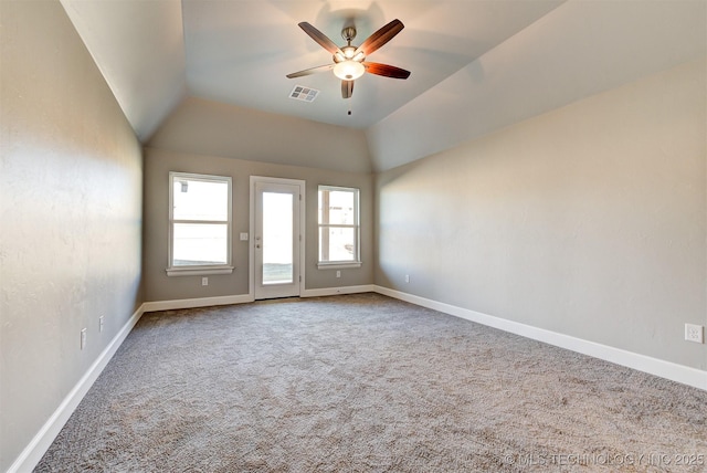 carpeted spare room with ceiling fan and lofted ceiling