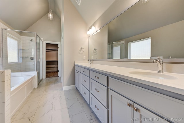 bathroom featuring lofted ceiling, plus walk in shower, vanity, and plenty of natural light