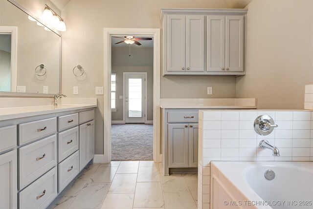 bathroom with vanity, a bath, and ceiling fan