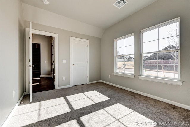 unfurnished bedroom with lofted ceiling and carpet