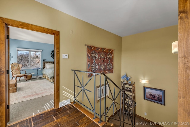 hallway with hardwood / wood-style flooring