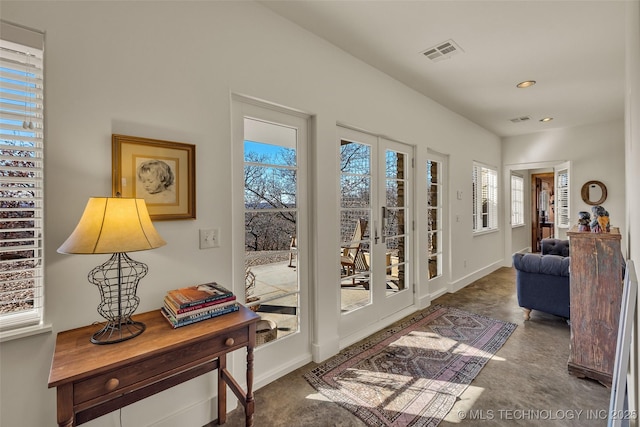 entryway featuring concrete floors and french doors