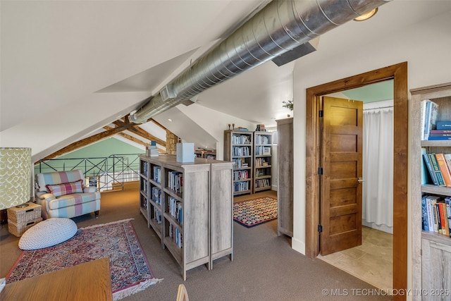 interior space with carpet flooring and vaulted ceiling