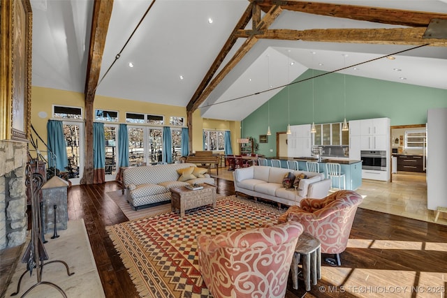 living room featuring beam ceiling, light hardwood / wood-style floors, and high vaulted ceiling