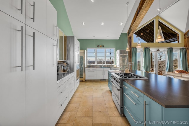 kitchen featuring sink, beamed ceiling, stainless steel appliances, and white cabinets