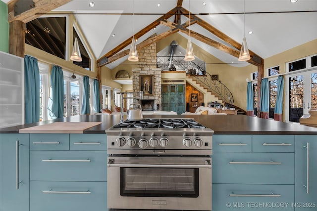 kitchen featuring blue cabinets, beam ceiling, hanging light fixtures, stainless steel range with gas cooktop, and a fireplace