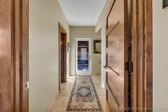 hall with light tile patterned floors