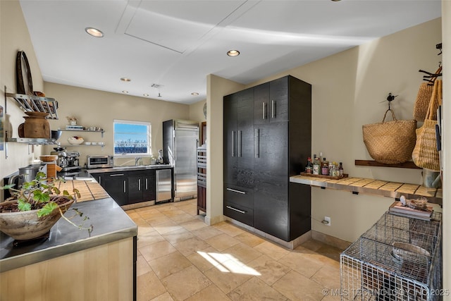 kitchen featuring stainless steel appliances, stainless steel counters, and sink