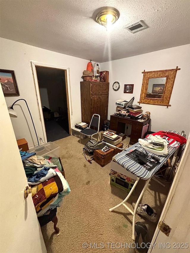 home office with carpet flooring and a textured ceiling