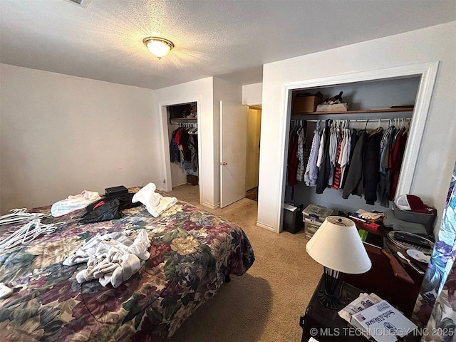 bedroom with light carpet and a textured ceiling