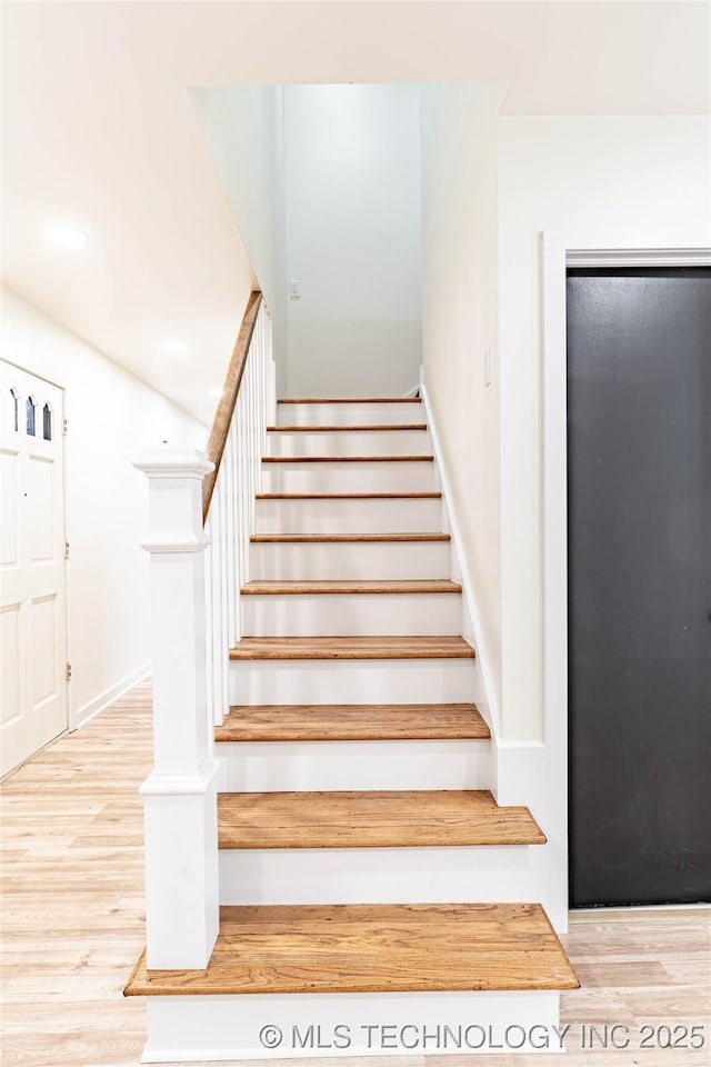 staircase with wood-type flooring