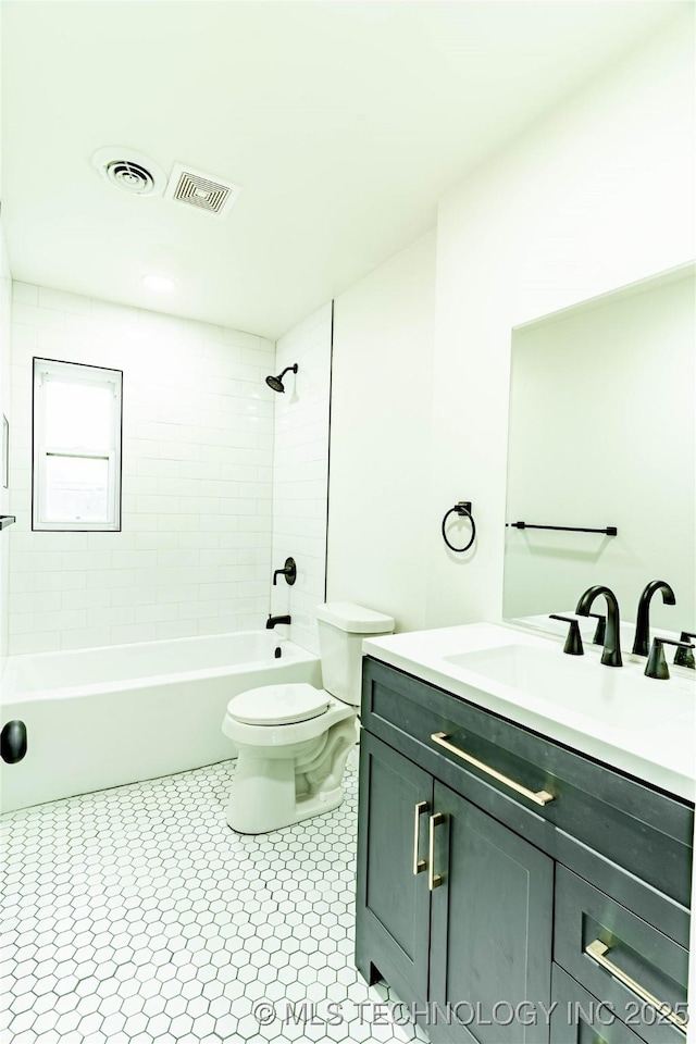 full bathroom with vanity, toilet, tiled shower / bath combo, and tile patterned flooring
