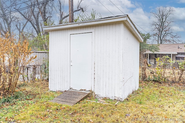view of outbuilding with a lawn