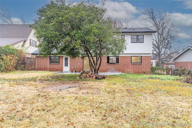 back of house with a lawn