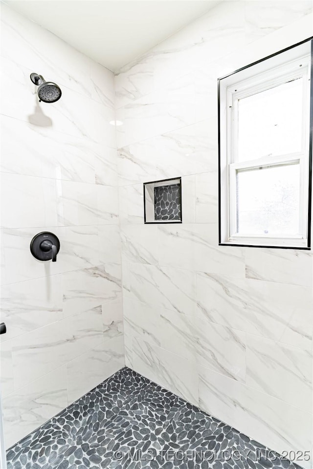 bathroom with tiled shower