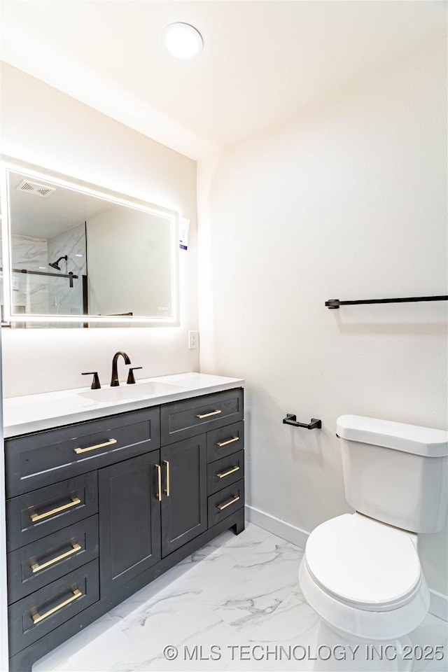 bathroom featuring vanity, toilet, and a shower with door