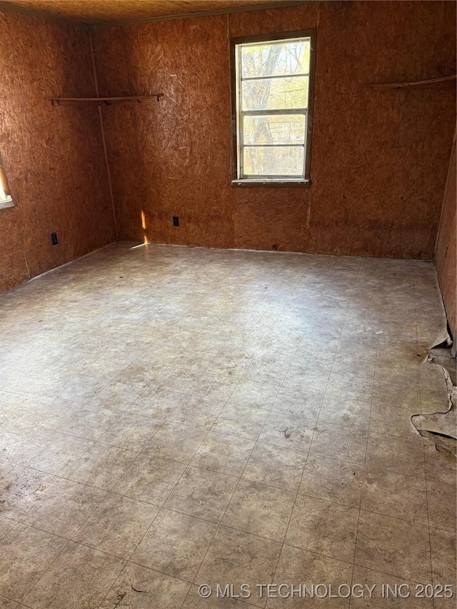 empty room featuring wooden walls