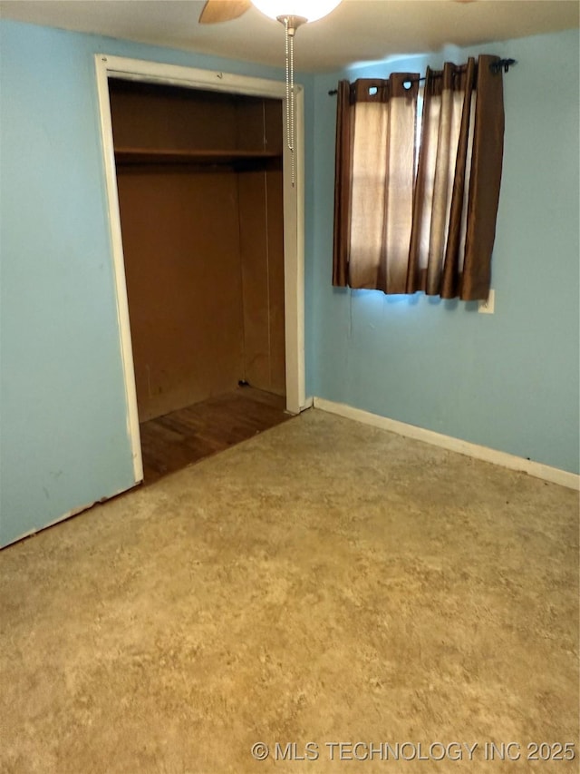 unfurnished bedroom with carpet floors, ceiling fan, and a closet