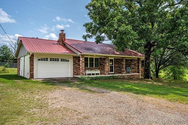 ranch-style home with a garage, a front yard, and covered porch