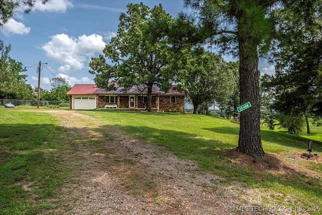 single story home with a garage and a front yard