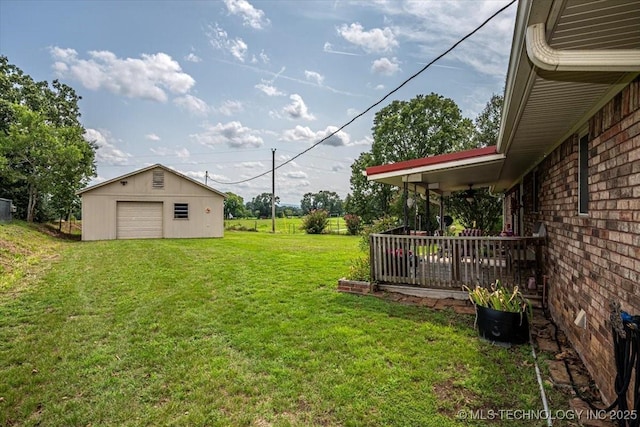 view of yard featuring a garage, an outdoor structure, and a deck