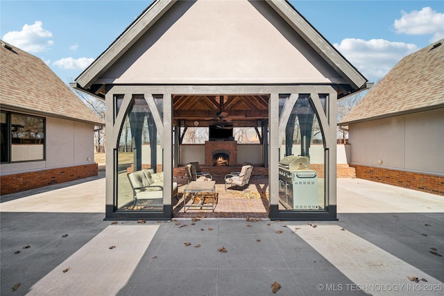 view of patio with an outdoor fireplace