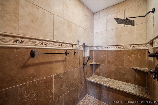 bathroom with tiled shower