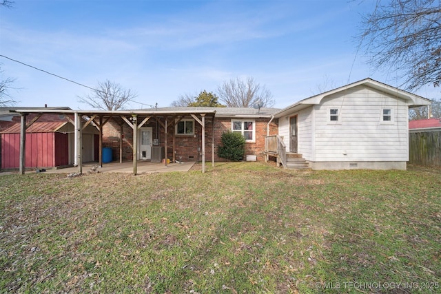 back of house featuring a lawn and a patio area