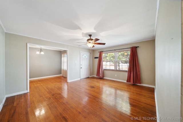 unfurnished room with ornamental molding, ceiling fan with notable chandelier, and hardwood / wood-style floors