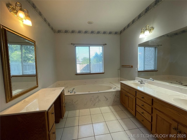 full bathroom with double vanity, a tub with jets, a sink, and tile patterned floors